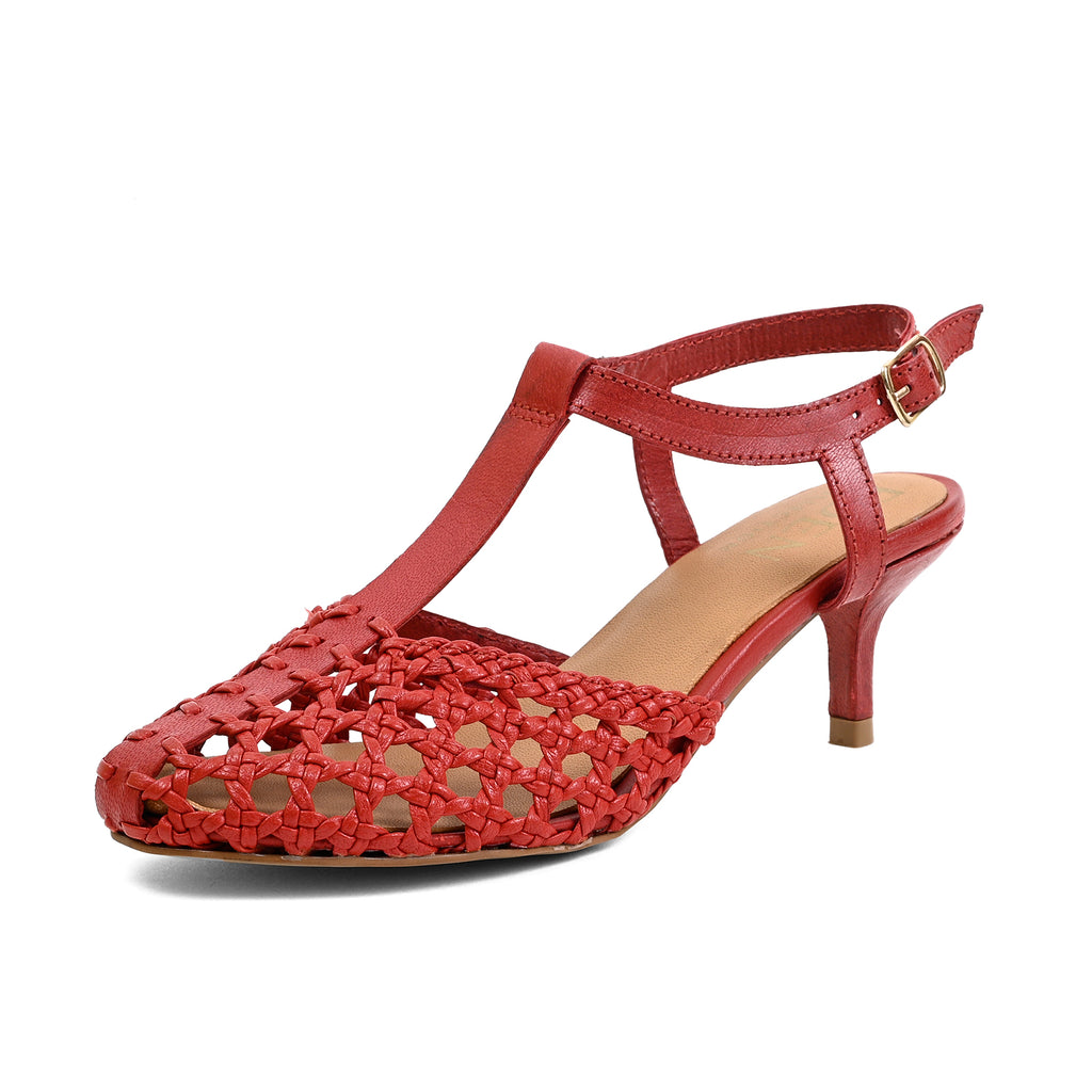A red leather T-strap sandal with a cutout pattern on the toe and heel, a mid-height kitten heel, and an adjustable ankle strap with a gold buckle, shown against a plain white background.