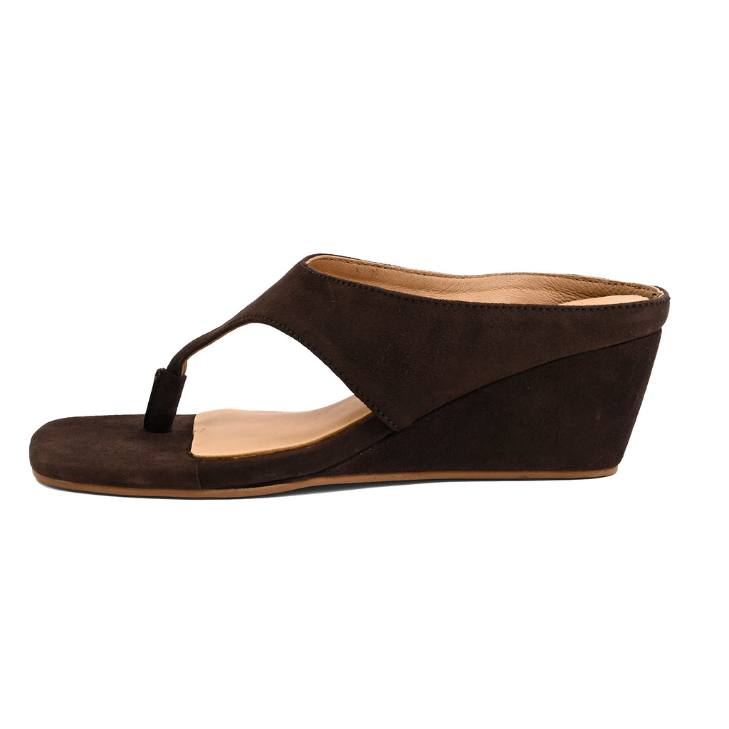 A single brown suede wedge mule sandal with a cutout toe strap, shown from a side profile on a white background.
