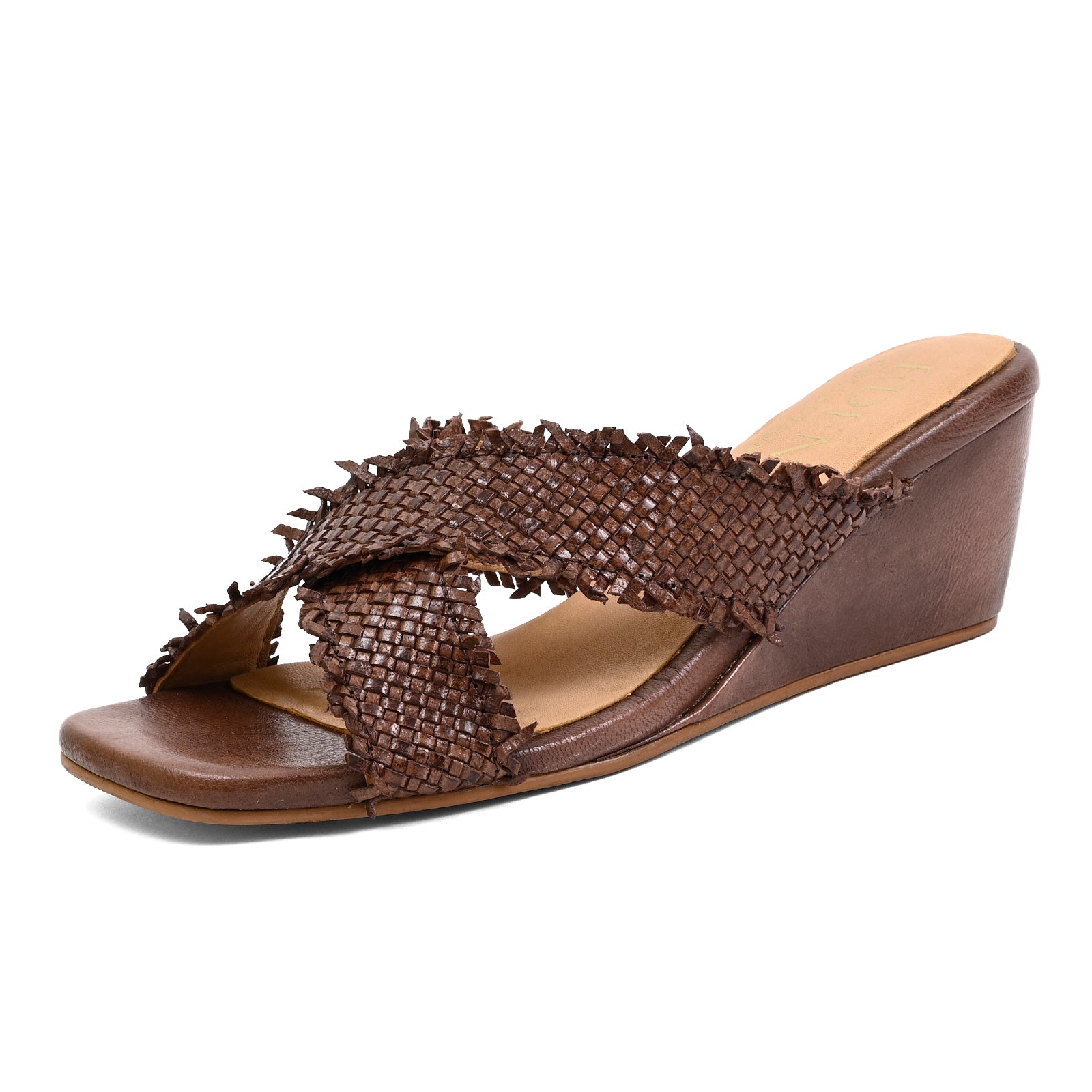 A brown wedge slide sandal with a woven textured strap and frayed fringe details, shown from a three-quarters angle on a white background.