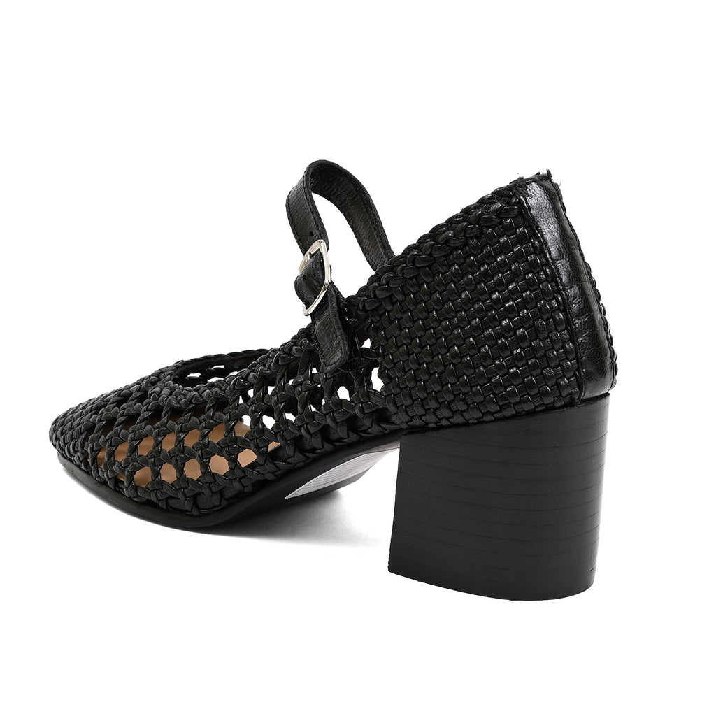 A black woven Mary Jane-style heeled shoe with a block heel and ankle strap, shown from a side-rear angle on a white background.