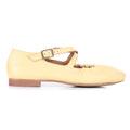 A pale yellow Mary Jane style shoe with a low block heel, a strap across the instep with a metal buckle, and a gathered detail at the toe, shown in profile against a white background.